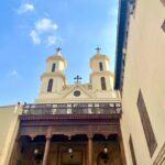 hanging church a large building with two towers and a cross on top