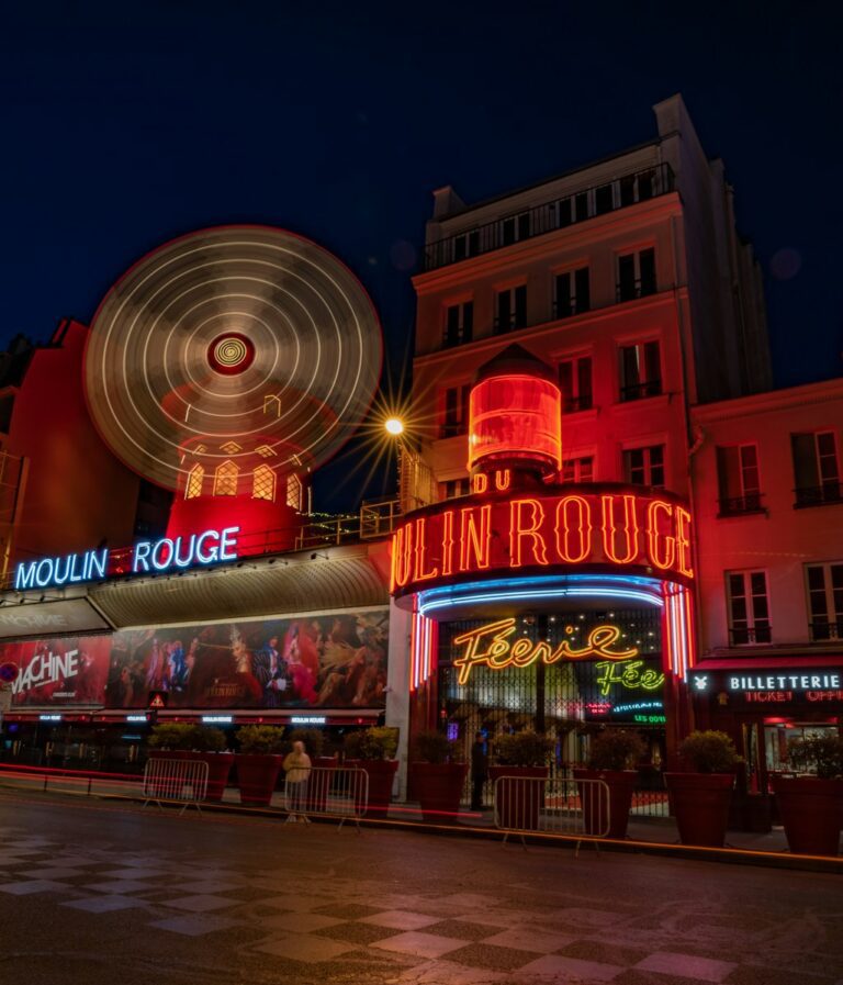 Paris Nightlife, a large ferris wheel in front of a building