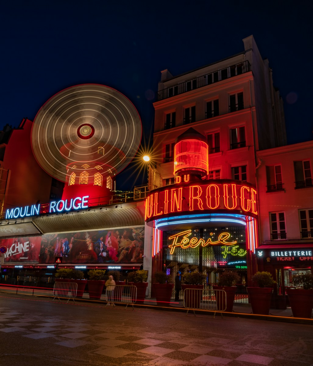 Paris Nightlife, a large ferris wheel in front of a building