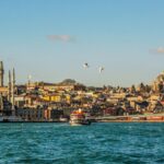 city buildings near body of water during daytime